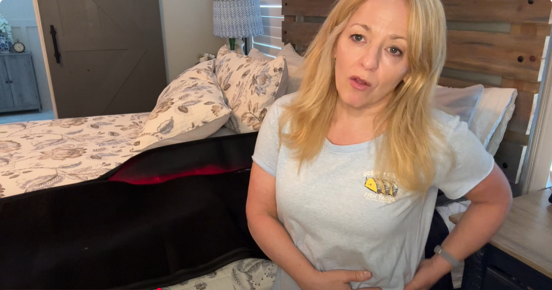 An woman is using a full-body red light therapy sleeping bag for recovery.