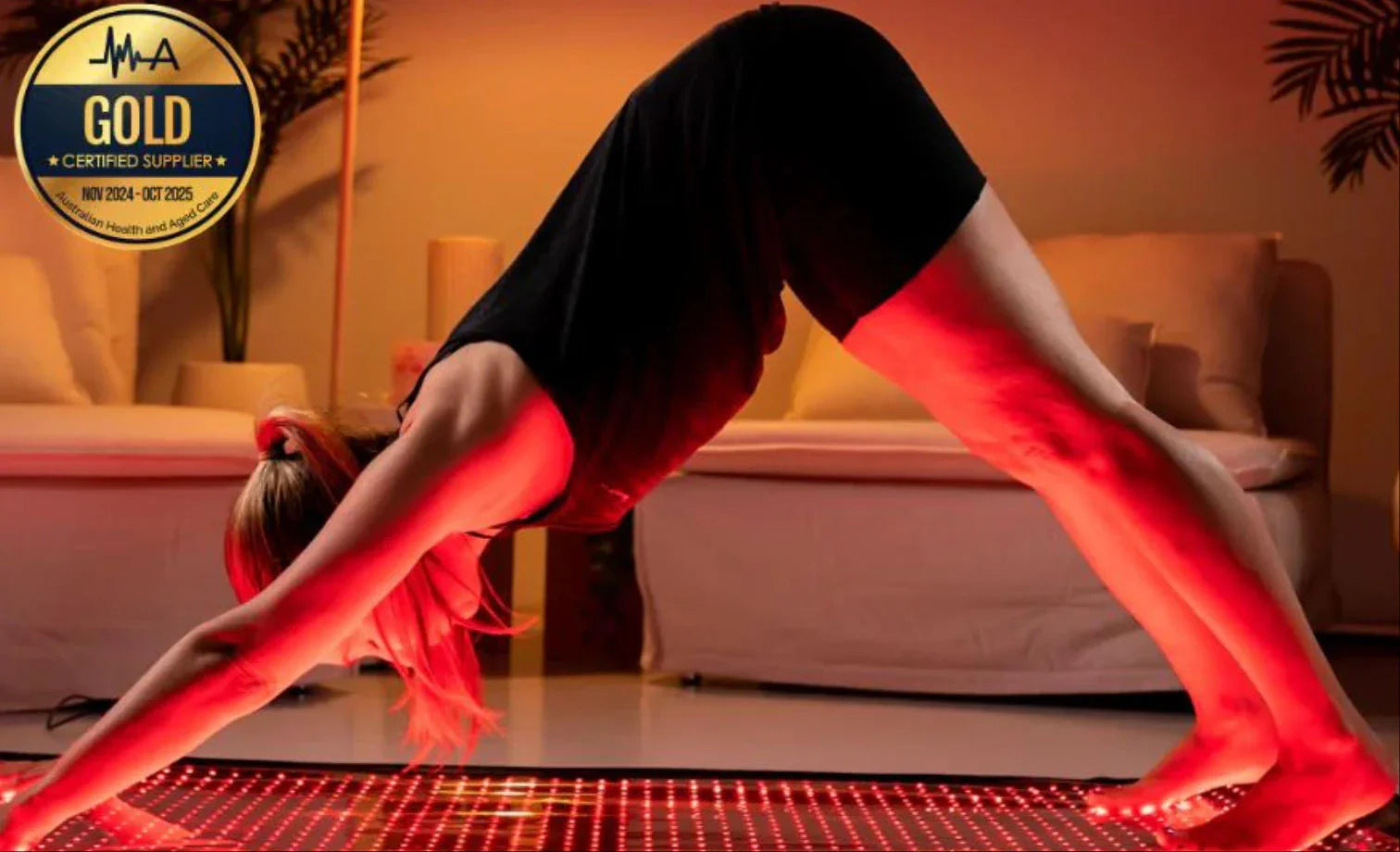 Woman doing yoga on red LED light therapy mat for pain relief and recovery